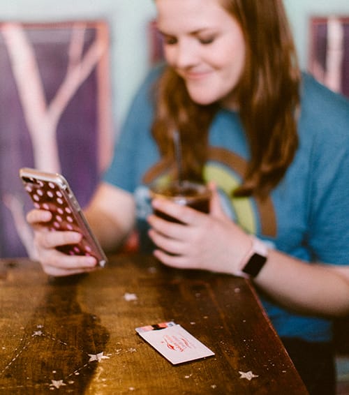 woman using phone and smiling