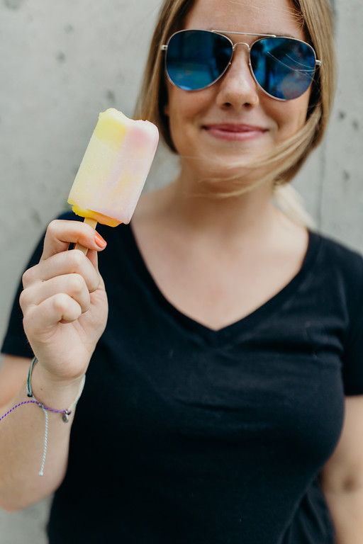 woman holding icecream and smiling