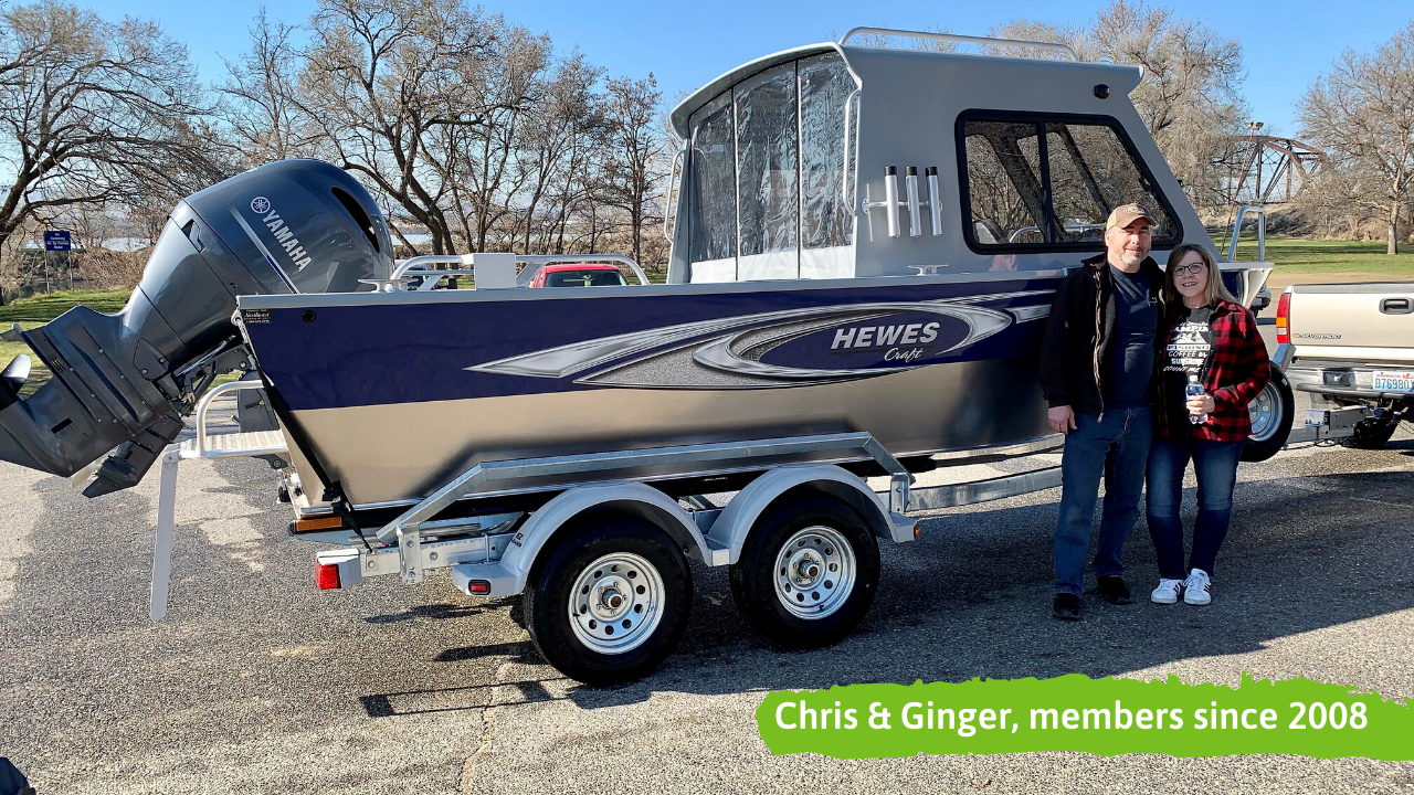 Canopy CU members next to their newly financed boat. Captioned "Chris & Ginger, members since 2008"