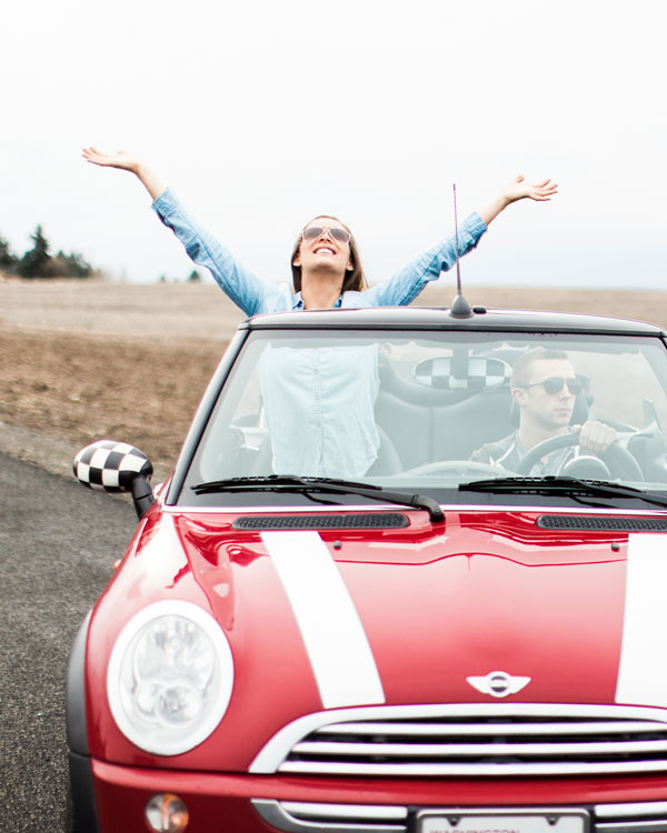 couple posing in car