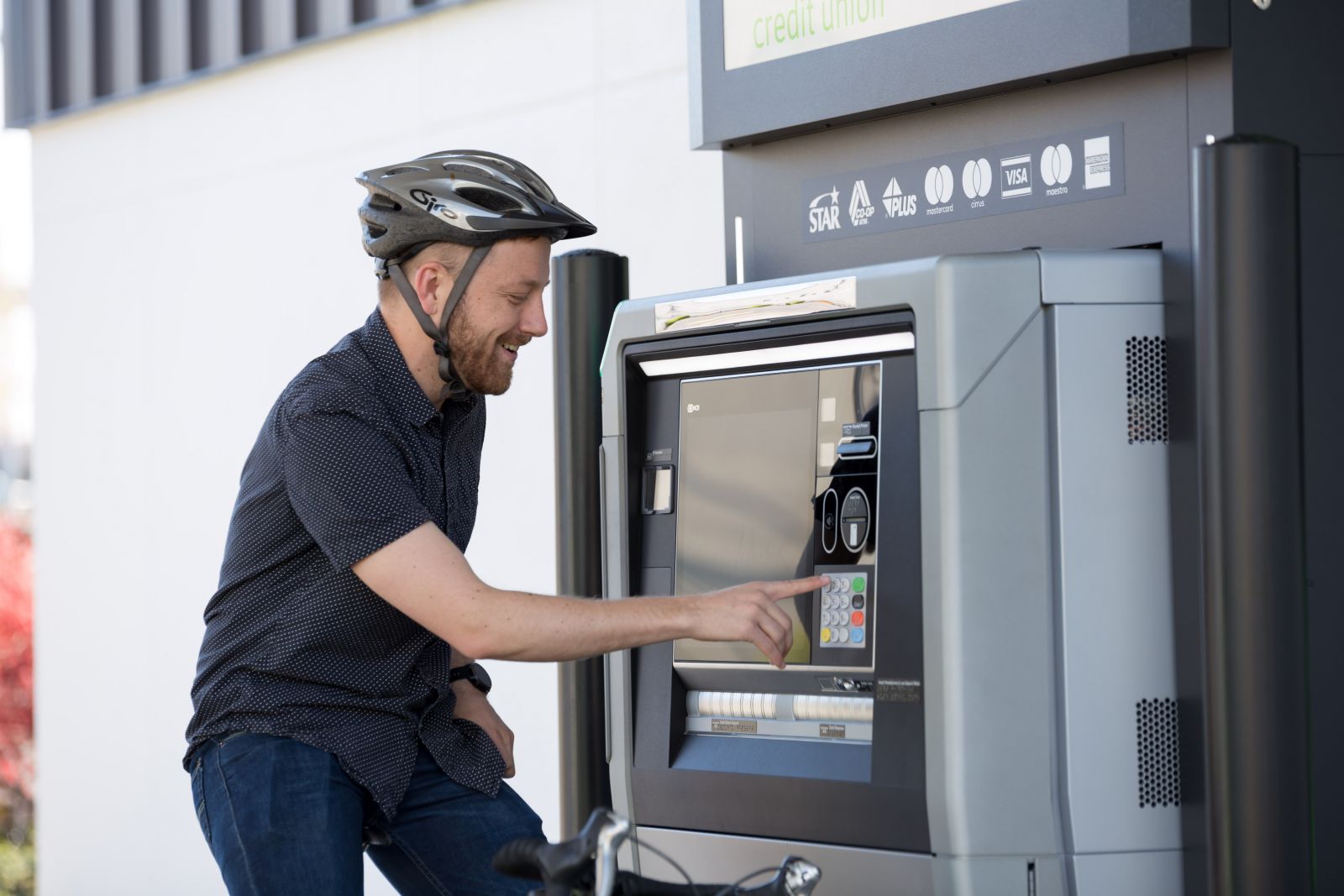 customer on bike using Canopy ATM