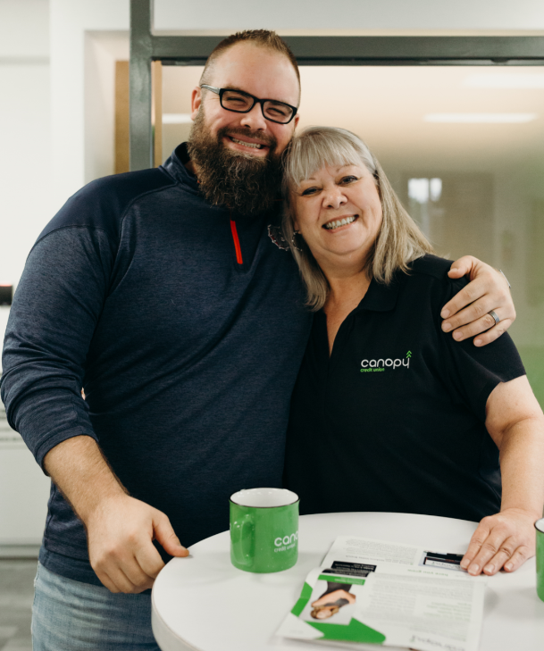 staff member with canopy cu member posing for photo